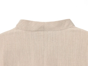 Close-up of the back collar seam and twill fabric texture on a beige casual blazer