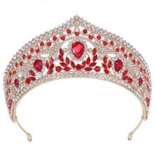 Detailed close-up of golden bridal tiara with sparkling red and clear rhinestones