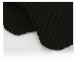 Detail of black ribbed knit fabric showing soft winter thermal texture and weave pattern