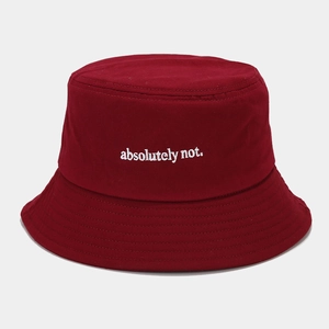 Detail of white 'absolutely not' embroidery on a dark red cotton twill bucket hat