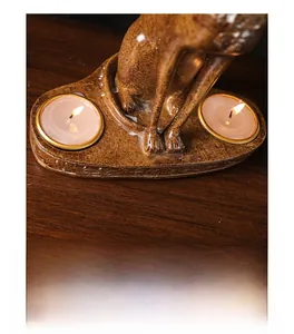 Detail of Egyptian Bastet cat double candle holder with ancient hieroglyphs and tea lights
