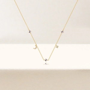 Detailed view of 925 silver gold-plated necklace with star, moon and purple crystal charms