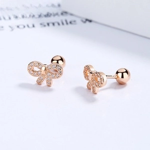 Detail of rose gold bow earrings with micro-pave cubic zirconia and screw-back ball closure
