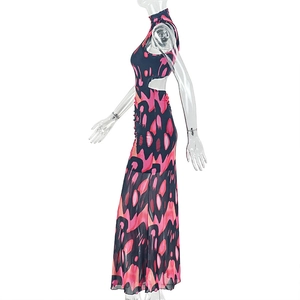 Detail of side cutout and geometric floral print on long high-neck maxi dress