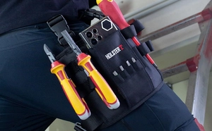 Close-up of durable Oxford cloth tool belt worn at waist with multiple pockets and slots