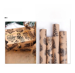 Detail of Christmas brown kraft paper rolls with black festive prints for gift wrapping