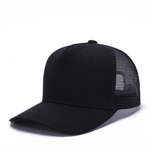 Detail shot of black trucker hat featuring breathable mesh panels and curved sun visor