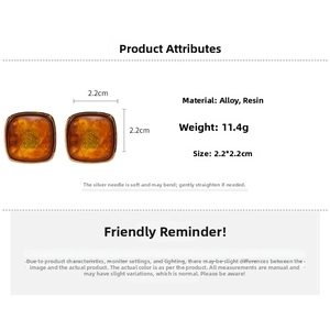 Detail showing 2.2cm square amber resin stud earrings with gold alloy frame measurements