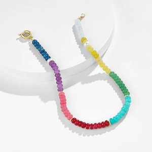 Detail shot of colorful round natural stone beads and gold-tone lobster clasp