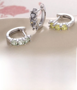 Detailed view of silver-plated copper hoop earrings with inlaid white and yellow zircons