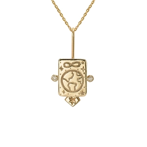 Close-up of gold tarot pendant with earth, infinity symbol, and sparkling zircon stones