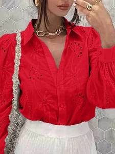 Detail of red hollow embroidered long sleeves and V-neckline on women's casual blouse