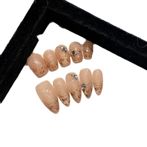 Handmade press-on nails featuring leopard print, gold glitter accents, and star metallic charms