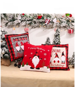 Detailed view of three Christmas gnome pillowcases with red and black plaid borders