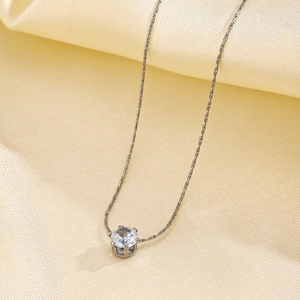 Silver 6-prong round zircon pendant necklace on luxury champagne satin background