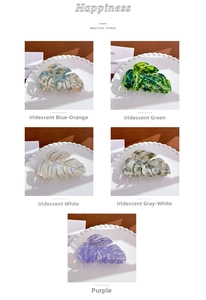 Detail view of five marble texture monstera leaf hair claws in various colors