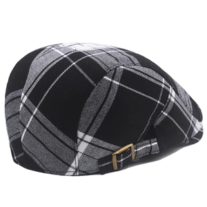 Detail of black and white plaid ivy cap featuring a vintage bronze metal adjustment buckle