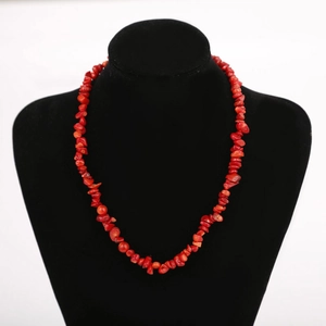 Detail view of handmade natural red crystal stone necklace on black velvet mannequin stand