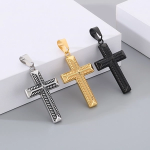Detailed view of textured cross pendants in silver, gold and black finishes