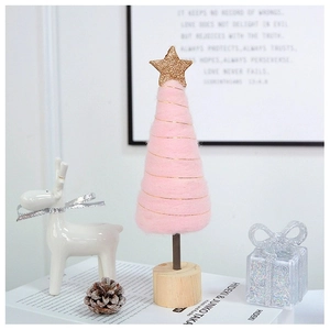Detailed view of pink felt Christmas tree with golden wire and star on wood base