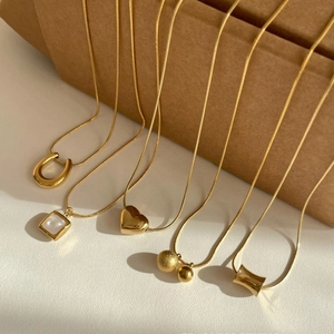 Golden titanium steel necklaces collection featuring horseshoe and heart pendants