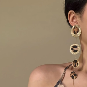 Exaggerated leopard print layered circle drop earrings with gold finish and tassels