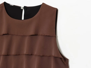 Detailed close-up of brown sleeveless satin top featuring tiered ruffle layers and fine texture