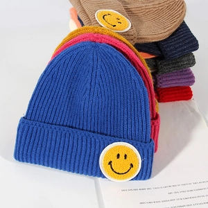 Knitted ribbed beanie hats for couples in multiple colors with a central smiley patch