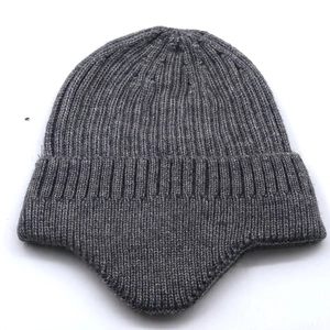 Close-up of dark grey ribbed knit beanie with ear flaps and warm fleece lining