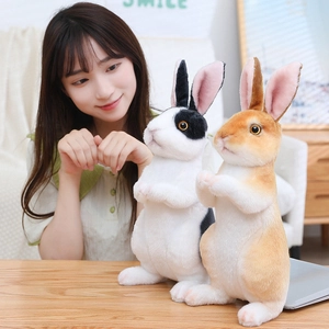 Detailed view of two realistic plush rabbits in black and brown floral patterns
