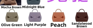 Polished leather handbags in various colors showing unique curved fold detail and single handle