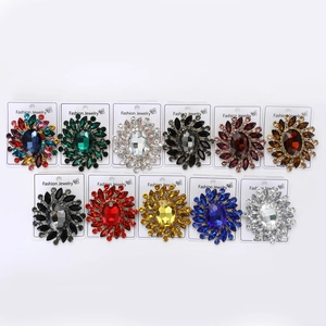 Detail of assorted vintage alloy brooches with radiant rhinestones on display cards