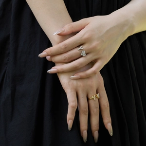 Close-up of S925 sterling silver heart and V-shaped adjustable rings on model fingers