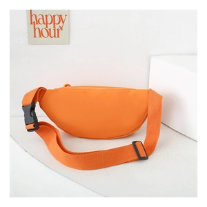 Close-up of bright orange nylon kids fanny pack featuring a durable black plastic buckle