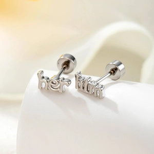 Minimalist silver 'Him' and 'Her' letter cartilage piercings in polished steel