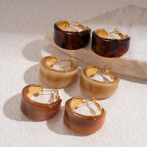 Three pairs of vintage C-shape resin hoop earrings in dark tortoise and marble patterns