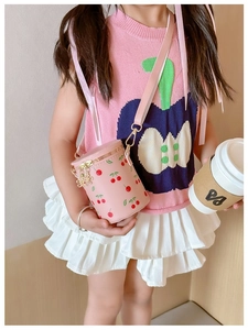 Pink cylinder bucket bag for girls with cherry print and golden chain strap detail
