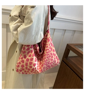 Detail of pink leopard print canvas tote bag featuring a thick shoulder strap design