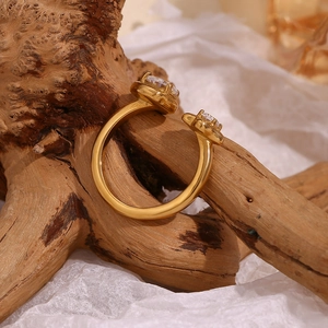 Detail of 18K gold-plated open ring with asymmetric star and teardrop zircon stones