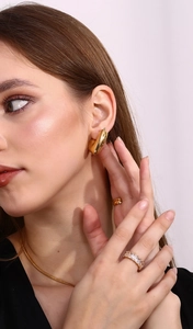 Detail shot of 18K gold plated snake chain necklace and square zircon ring on model