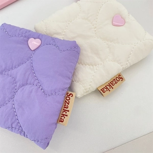 Quilted heart-patterned square storage pouches in soft purple and beige fabric colors