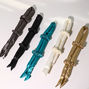 Five satin heatless hair curlers with matching scrunchies in various silk colors