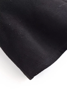 Close-up of black suede fabric texture showing detailed fiber material of the top
