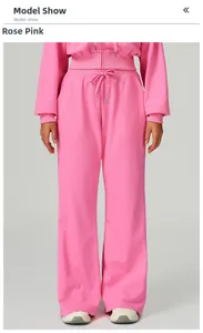 Full view of rose pink high waisted loose drawstring sports pants and matching hoodie