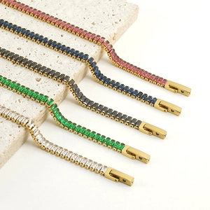 Five 18K gold plated tennis bracelets with colorful zircon stones on a stone base