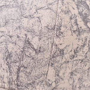 Macro shot of cracked marble texture and fine stitching on a vintage baseball cap