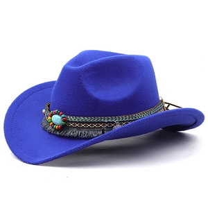 Detail view of the ethnic woven band with turquoise stone and fringe on a blue felt hat