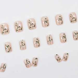 Floral press-on nail kit with pastel pink base and delicate white flower patterns