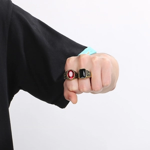 Detail of vintage carved rings with red and black stones on a man's hand