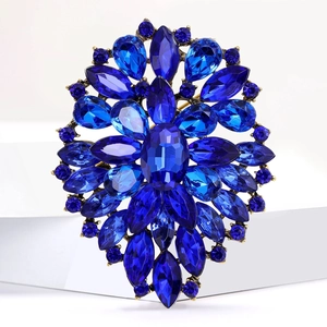 Close-up of radiant blue crystal floral brooch with intricate gold alloy petal details